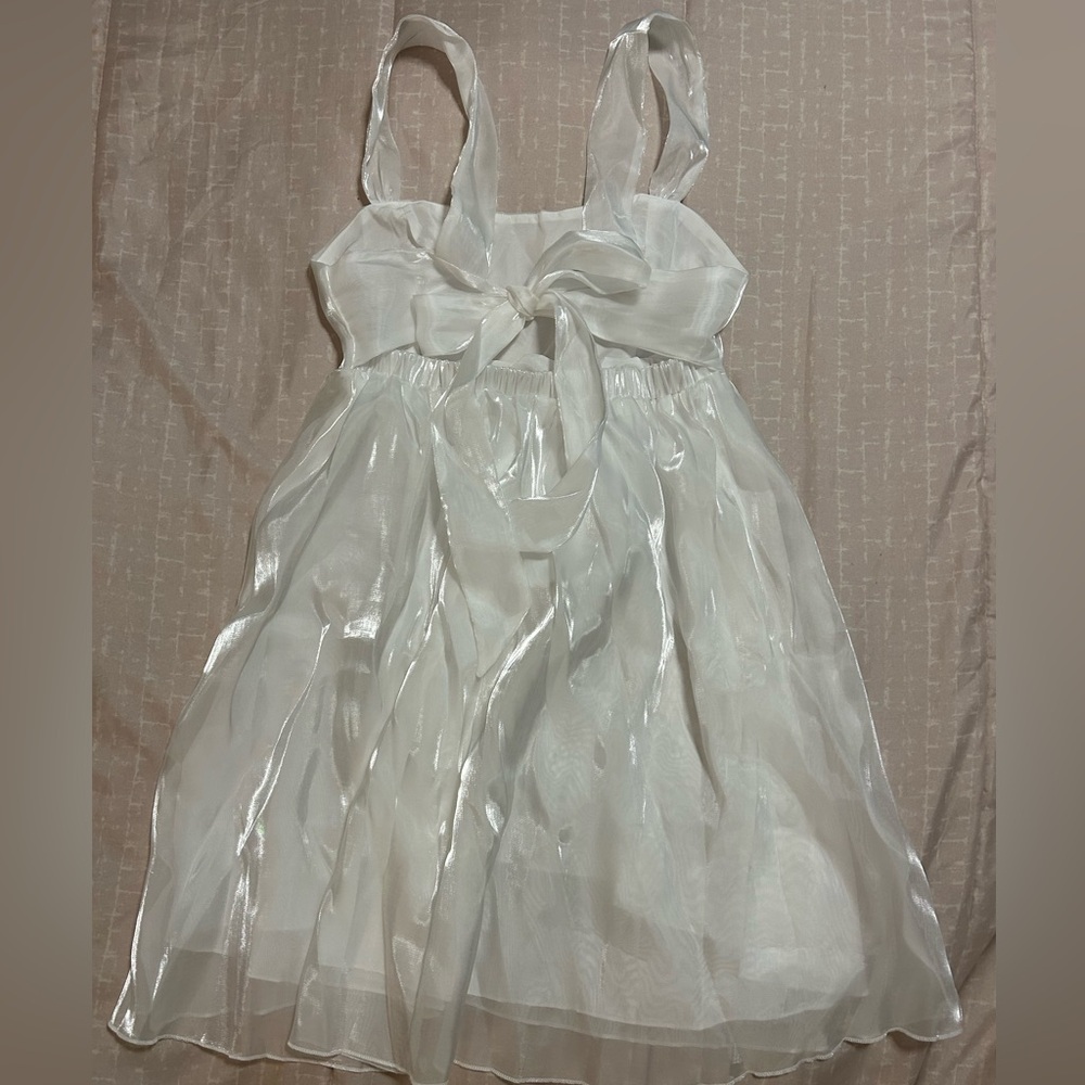 Gorgeous white fluorescent dress with bow in the back